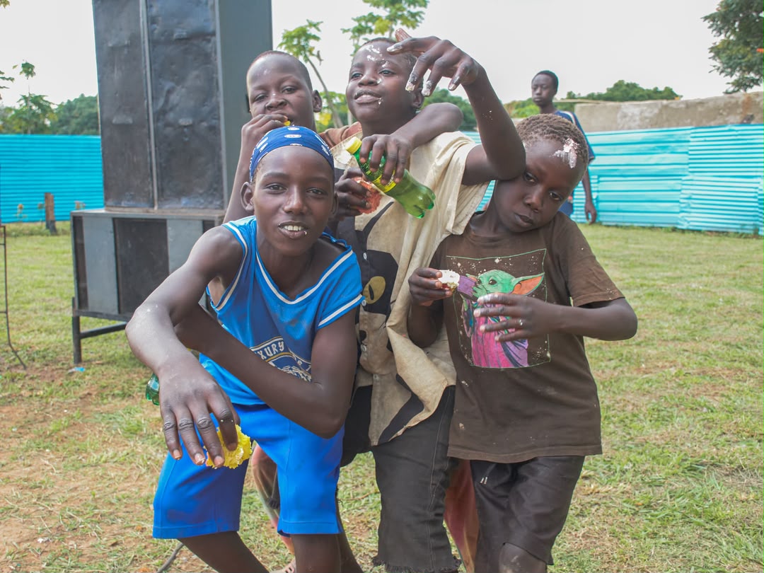 Boys smiling and playing together at a Roots of Hope Uganda outreach
